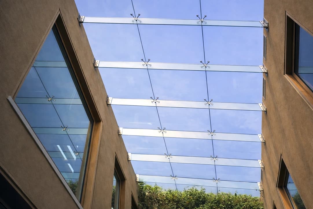 Pergola walkway with a glazed retractable roof