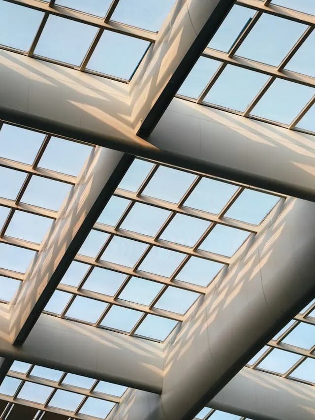 Angled skylight glazing panels with structural framing